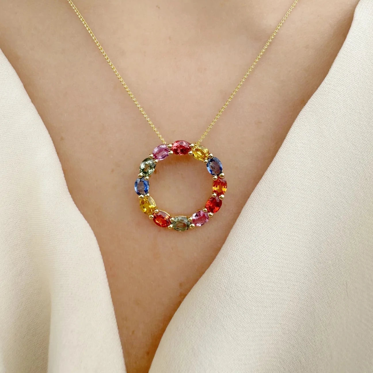 Rainbow gemstone circle necklace on yellow old chain.